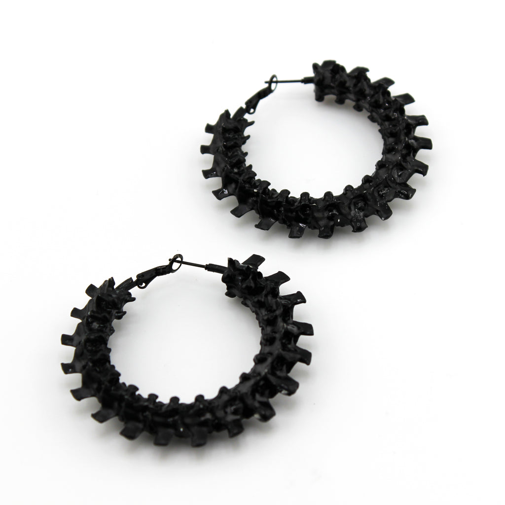 Black hoop earrings on a white background