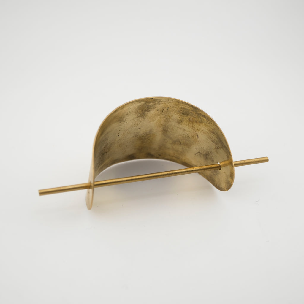 Brass hair clip on a white background