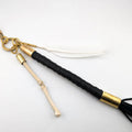Black and gold keychains on a white background