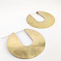 Pair of gold earrings on a white background