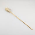 Decorative hair stick with bones and gold accents on a white background